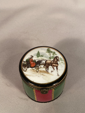 Regal porcelain trinket box the top has a horse and carriage driven by a lady