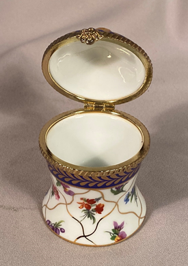 Unusual shaped Regal porcelain floral and gilt metal trinket box.